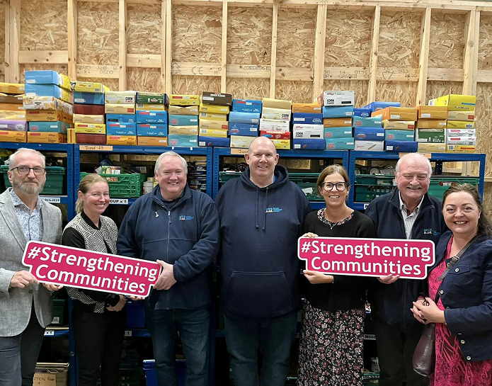BFCS team holding Strengthening Communities signs